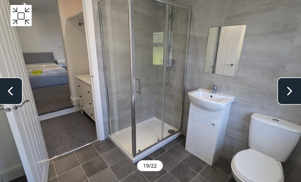 A modern and spotless bathroom featuring a spac...