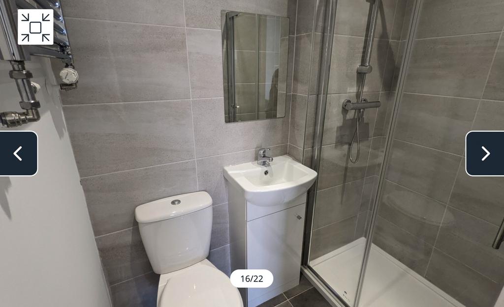 A modern and clean bathroom featuring a shower,...