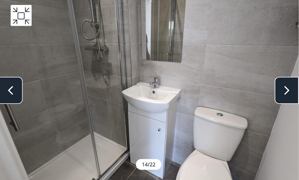 A modern and tidy bathroom featuring a sleek sh...