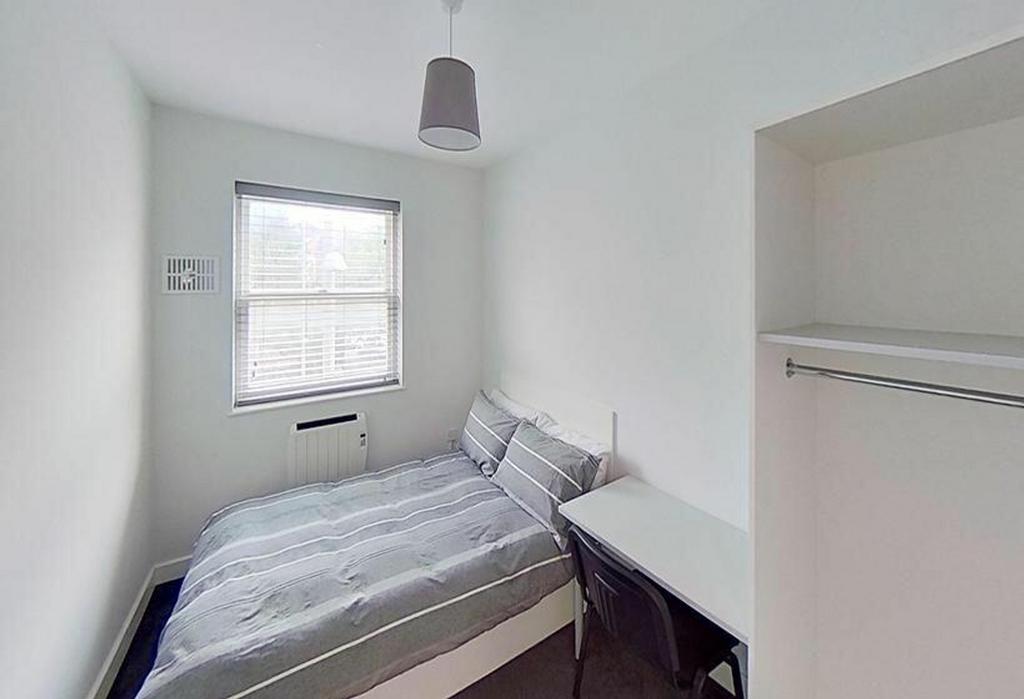 This inviting double bedroom features a comfort...