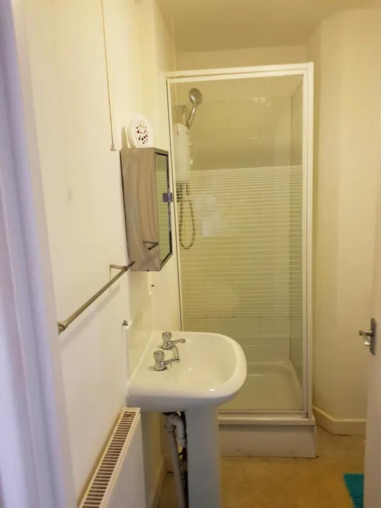 A clean and functional bathroom with a shower, ...