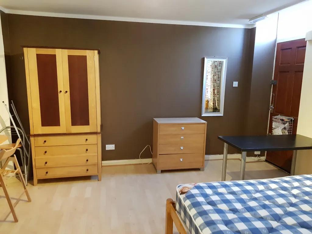 A spacious and tidy double bedroom featuring wo...