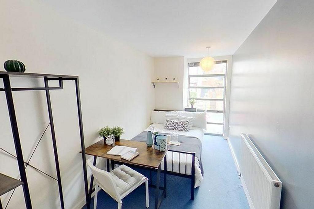 A bright and inviting double bedroom featuring ...