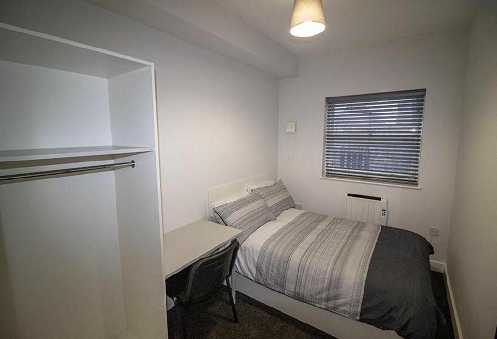 Cozy double bedroom featuring a comfortable bed...