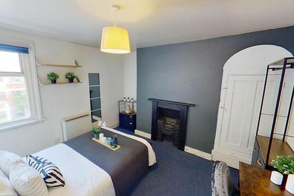 This charming double bedroom features a cozy de...