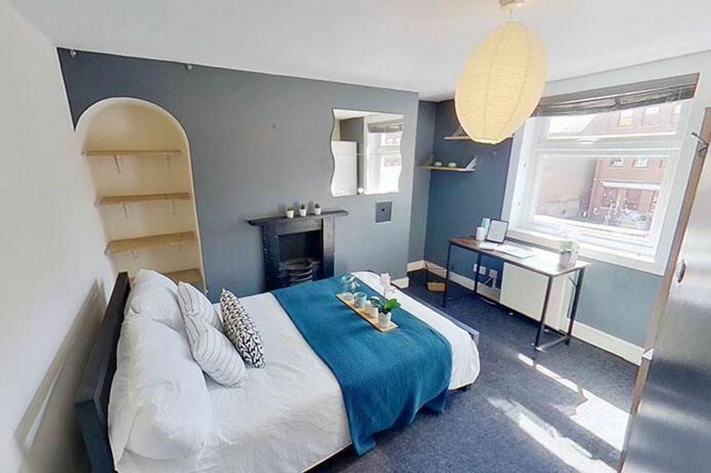 This inviting double bedroom features a cozy la...