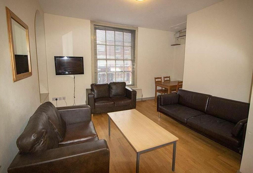 Spacious living room featuring comfortable leat...