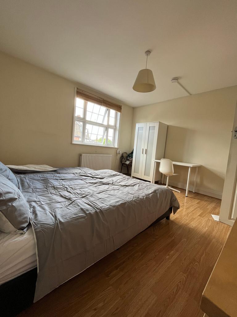 Spacious double bedroom featuring a comfortable...