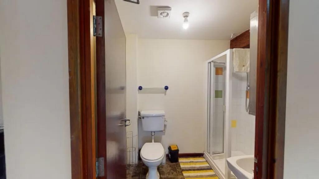 A well-maintained bathroom suite featuring a sh...