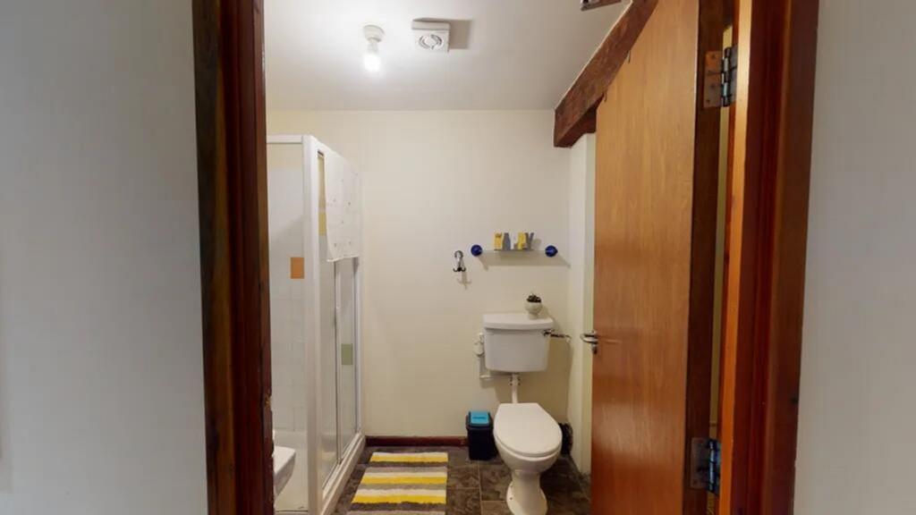 Bright and tidy bathroom featuring a shower, mo...