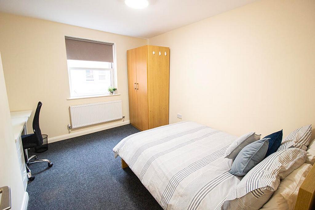 This inviting double bedroom features a comfort...