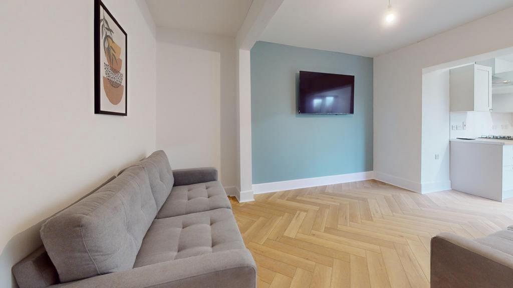 A spacious and stylish modern living room featu...