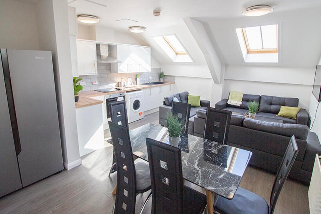 This contemporary kitchen and living area boast...
