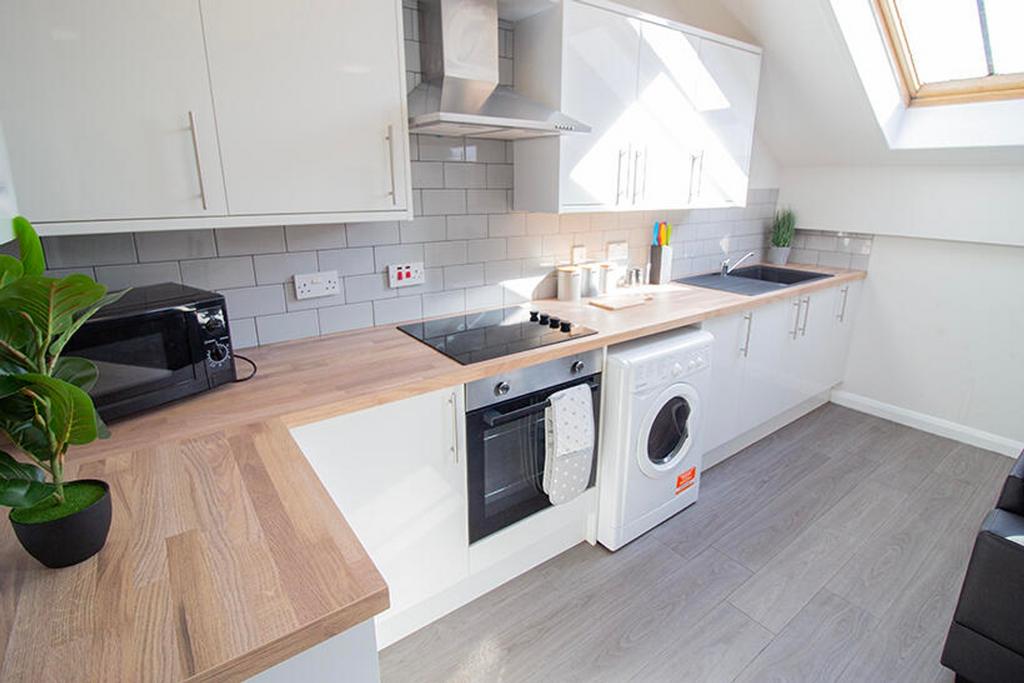 This modern kitchen features sleek cabinetry, a...
