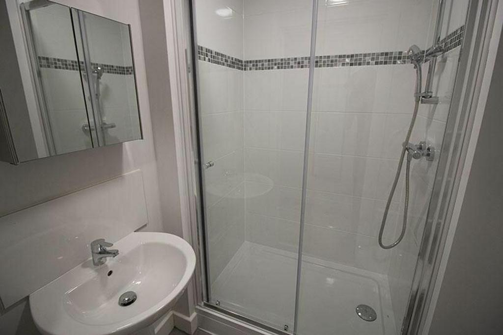Bright and modern bathroom featuring a walk-in ...