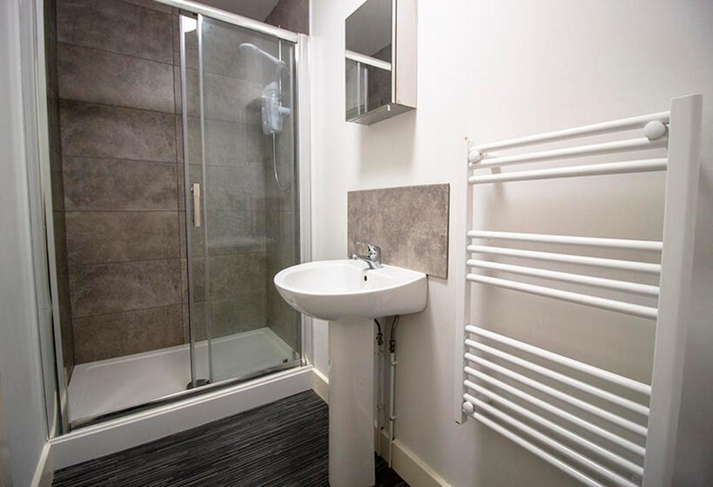 A modern bathroom featuring a sleek shower encl...