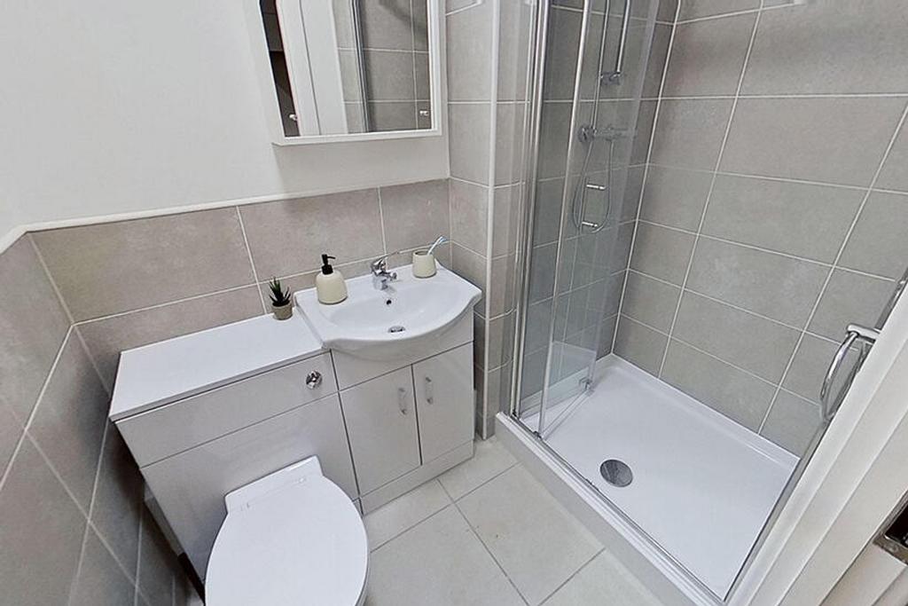 Modern bathroom suite featuring a sleek shower ...