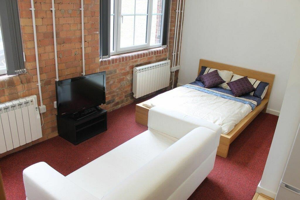 This inviting double bedroom features a cozy be...