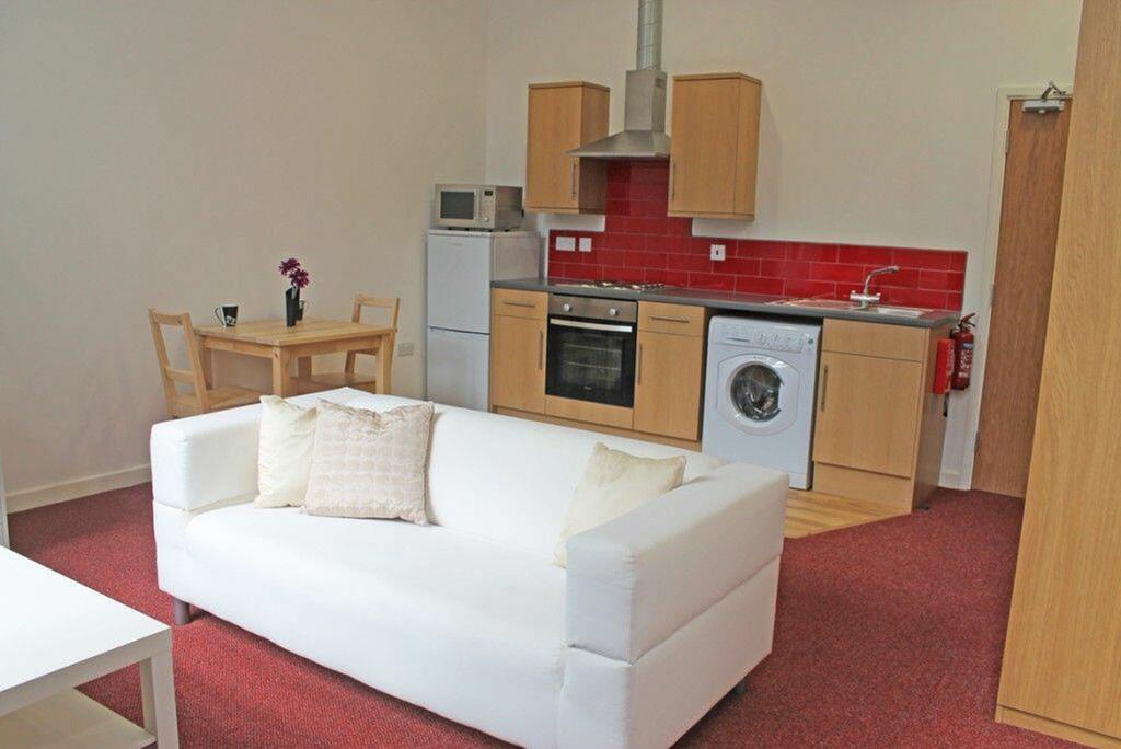 This inviting kitchen features modern appliance...