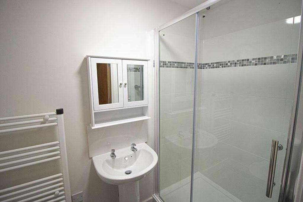A modern bathroom featuring a stylish shower en...
