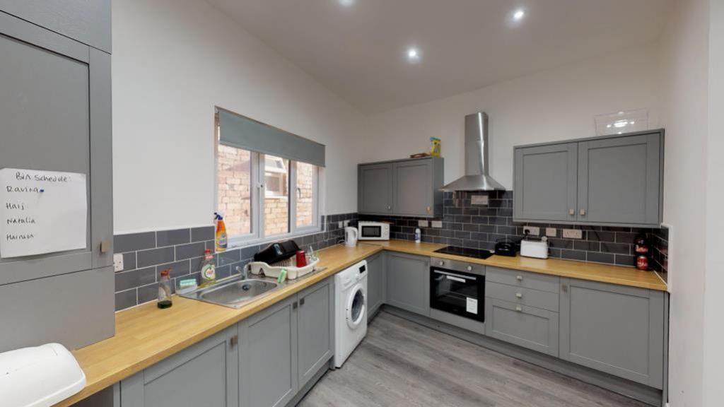 A modern and spacious kitchen equipped with ess...