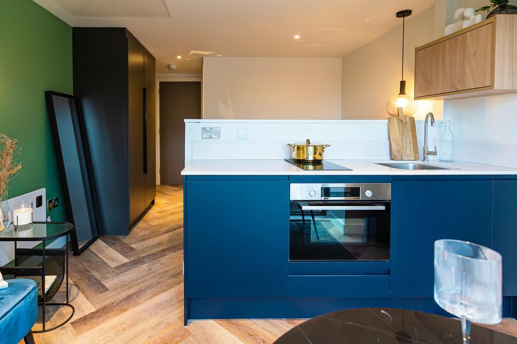 A modern and stylish kitchenette with ample spa...