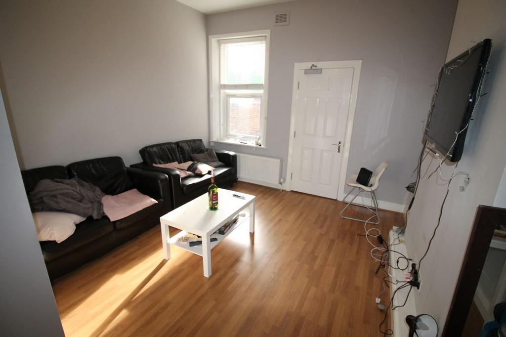 Spacious and inviting living room featuring com...