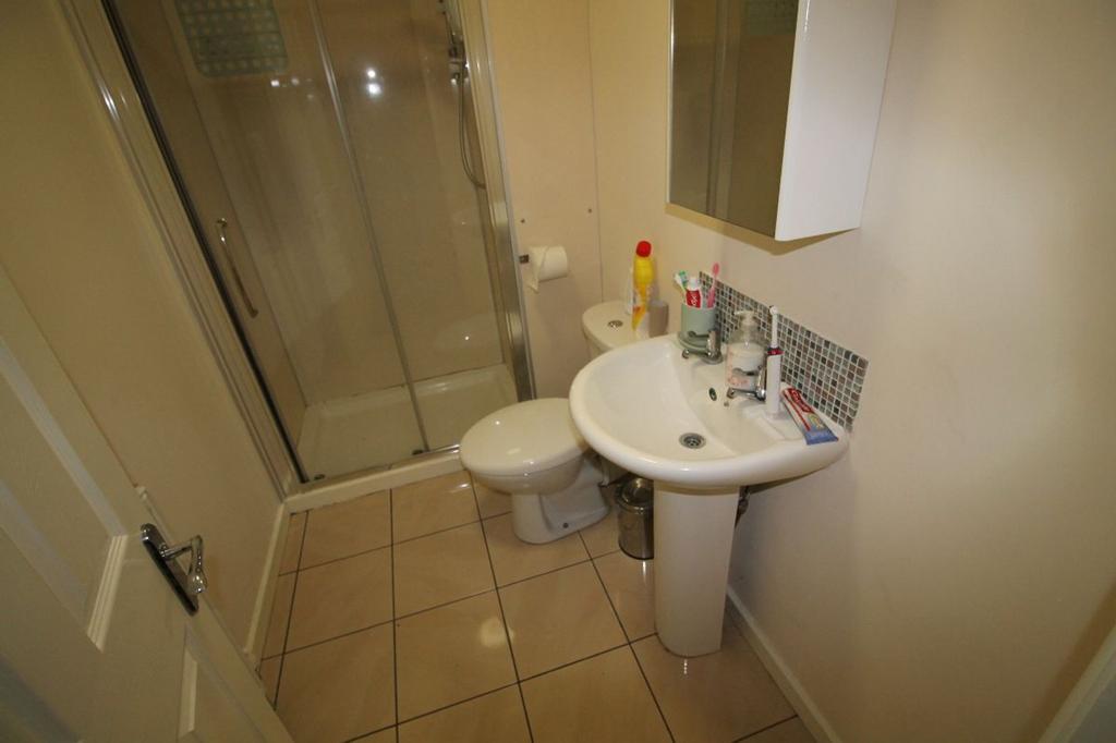 This well-maintained bathroom features a modern...