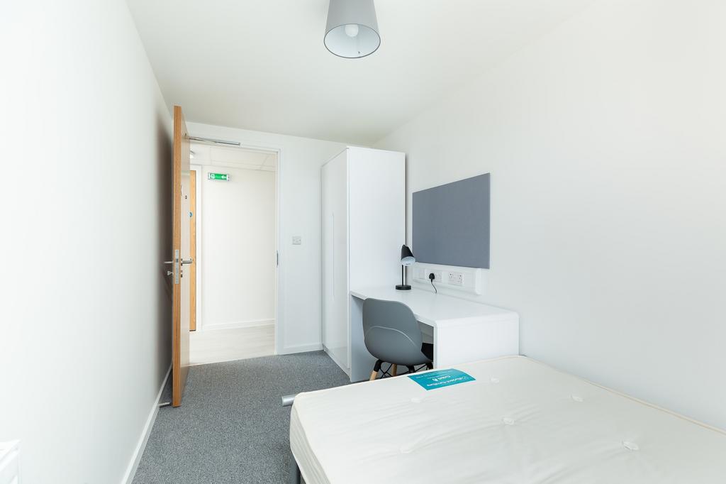 A bright and tidy double bedroom with modern fu...