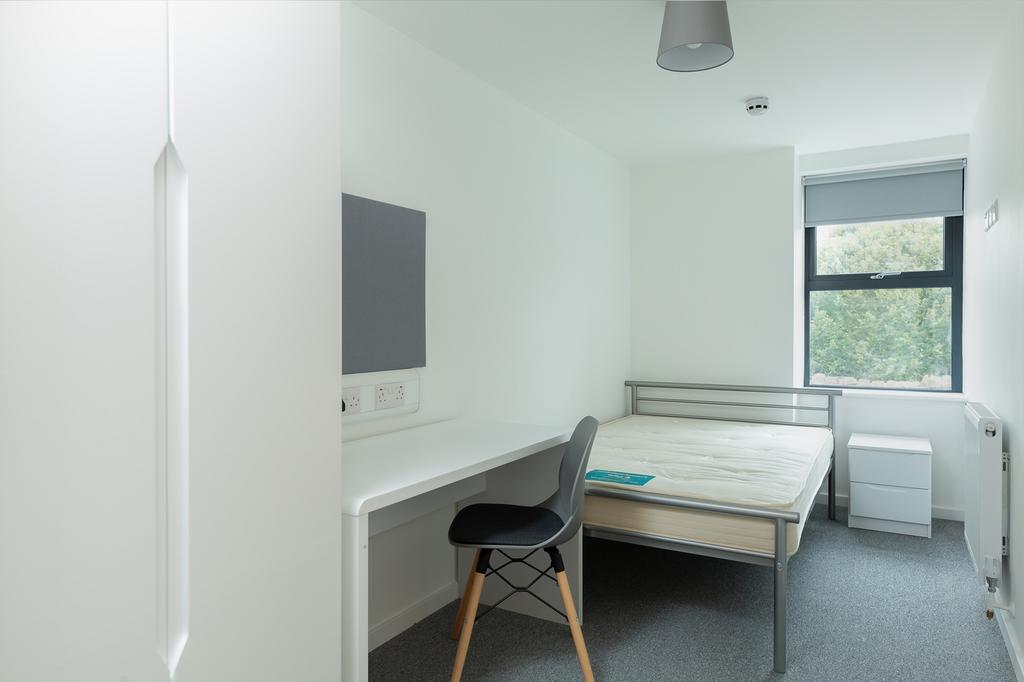 A bright and tidy double bedroom featuring a sp...