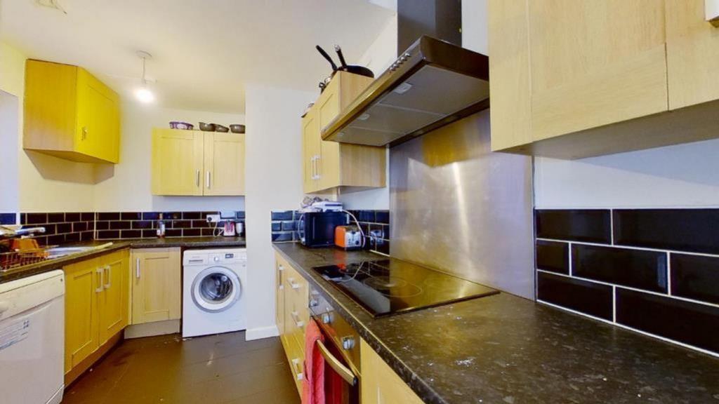 A modern and tidy kitchenette with ample storag...
