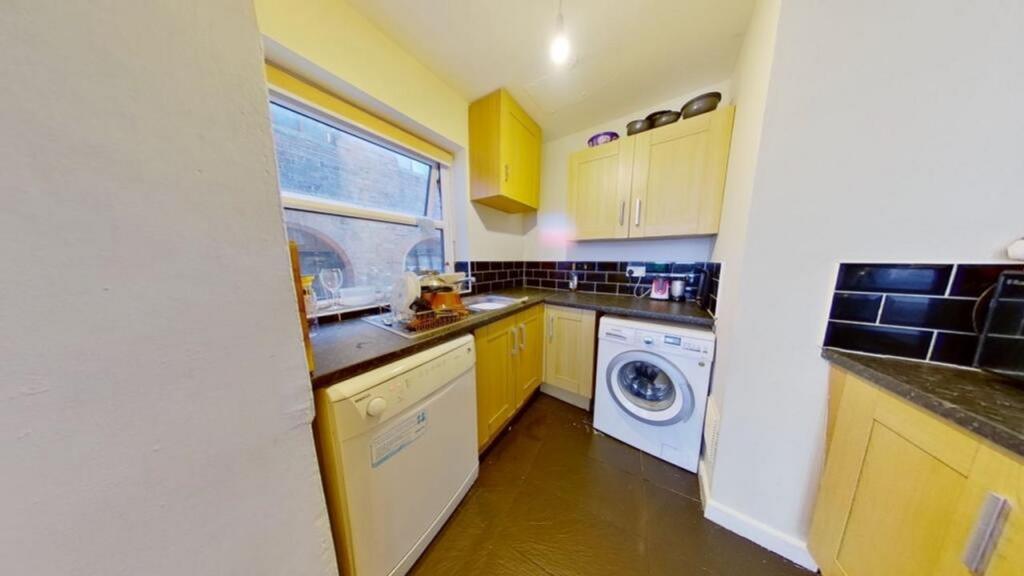 A bright and tidy kitchenette with modern appli...