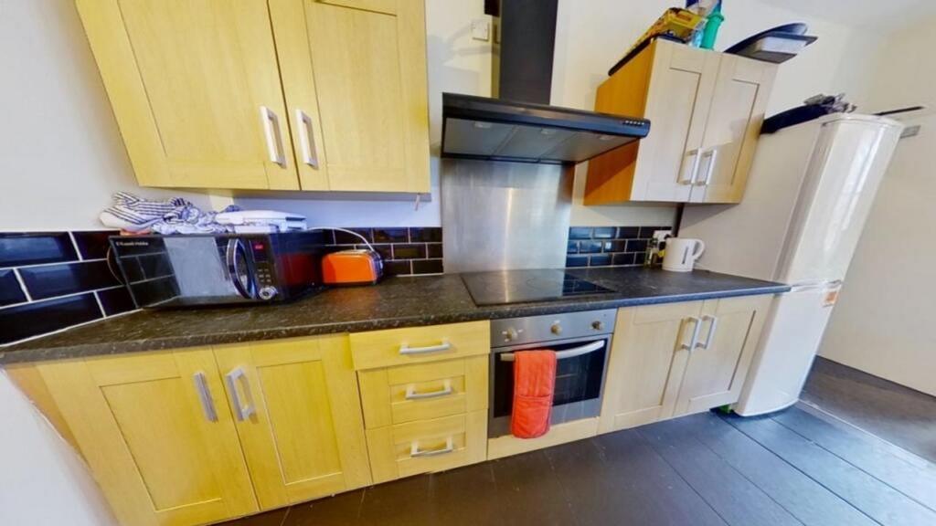 A modern kitchenette featuring ample storage an...