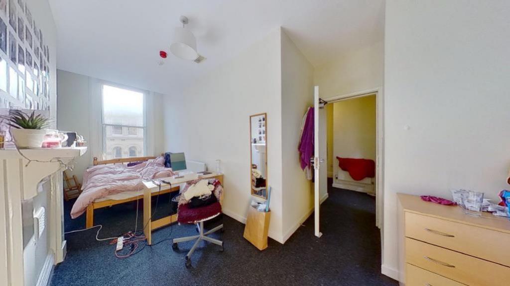 A well-lit and inviting double bedroom with amp...