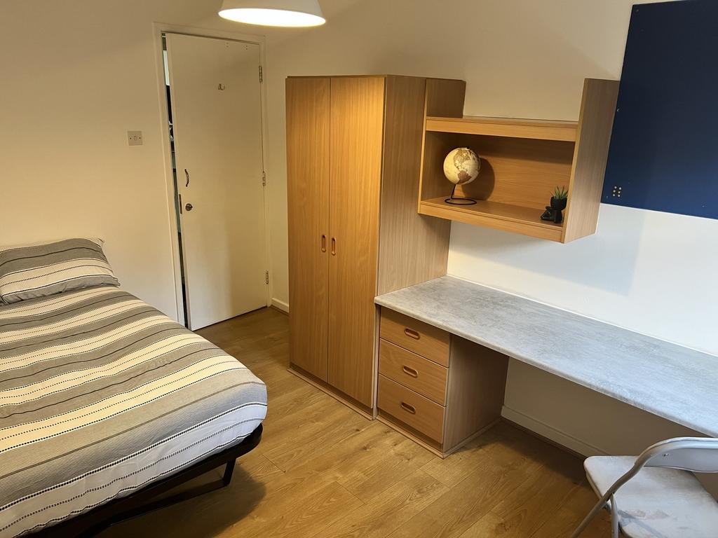 Spacious double bedroom featuring a comfortable...
