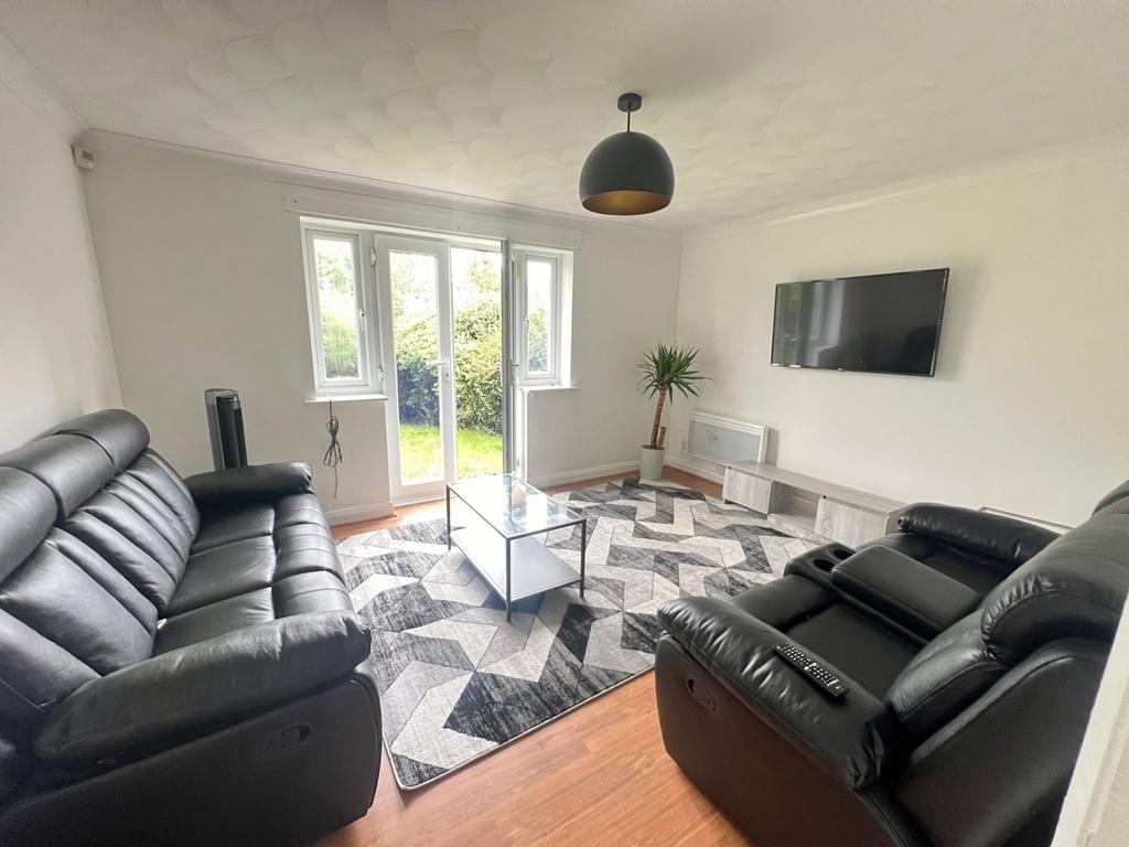 A spacious and inviting living room featuring m...