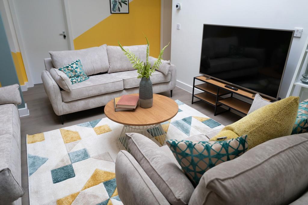 A spacious and inviting modern living room, per...