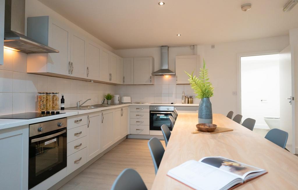 A bright and modern kitchen with ample space fo...