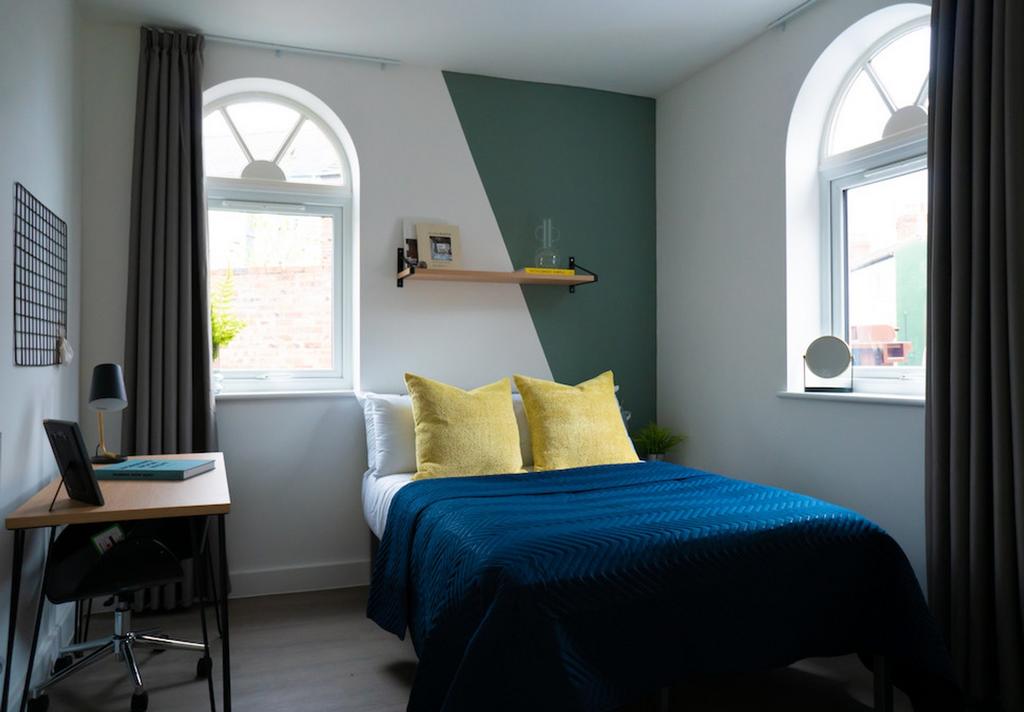 A stylish and well-lit double bedroom featuring...