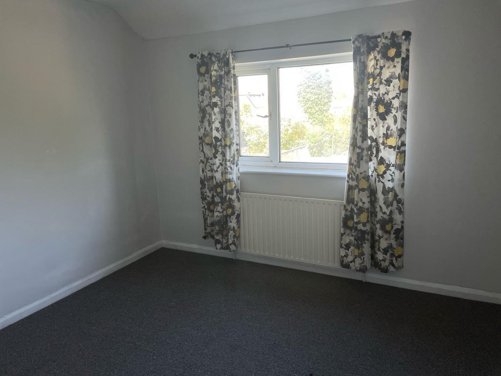 Spacious double bedroom featuring large windows...