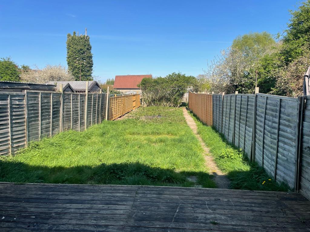 A spacious garden with a well-maintained lawn, ...