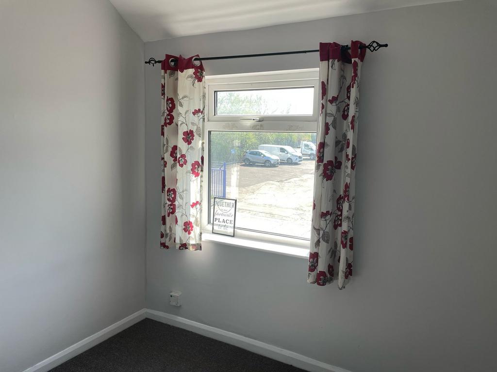 This inviting double bedroom features bright na...