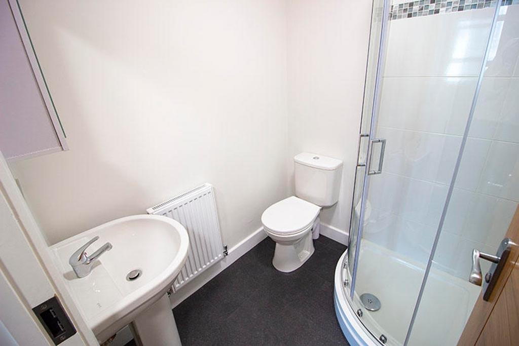 Modern bathroom featuring a spacious shower, sl...
