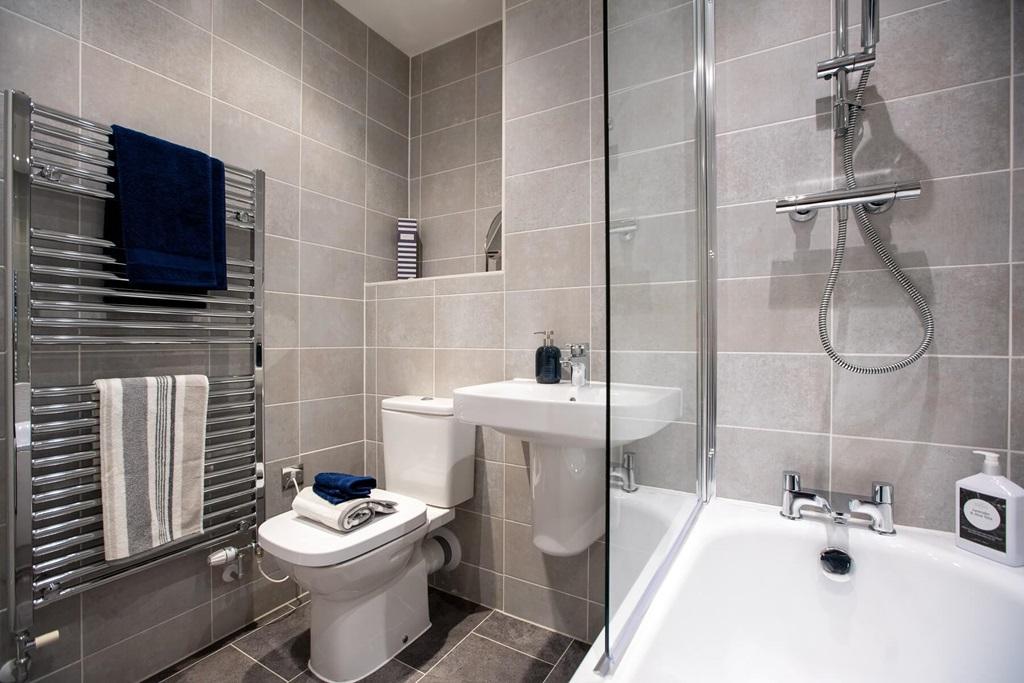 A main bathroom with high quality fixtures and...