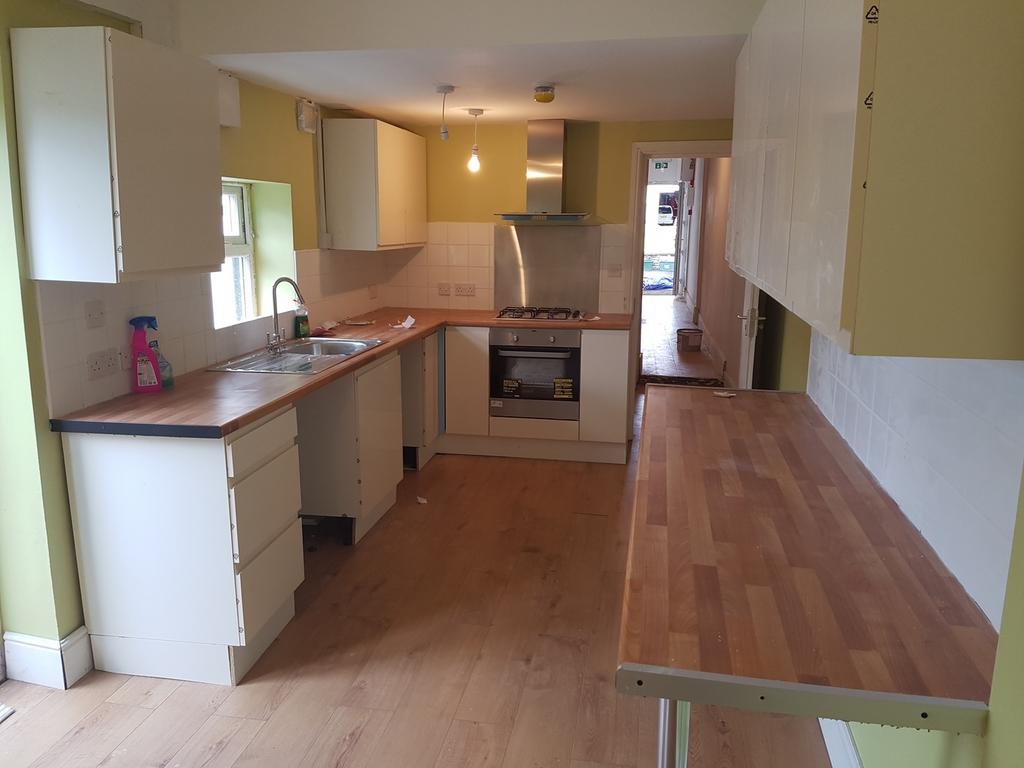A spacious and tidy kitchenette with modern app...