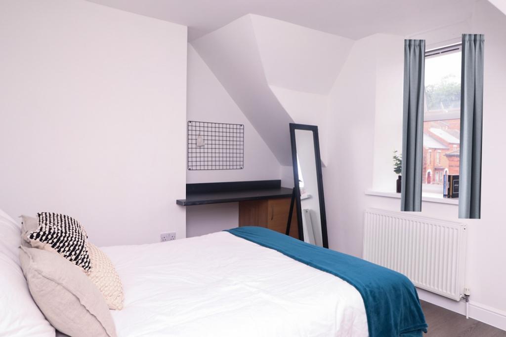 A bright and inviting double bedroom featuring ...