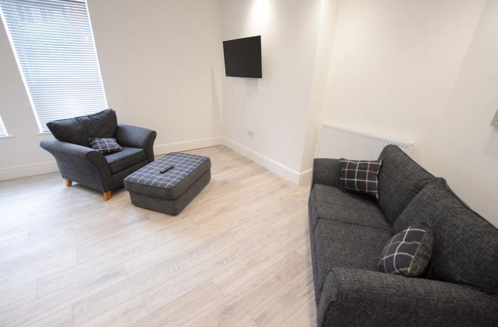 A spacious and inviting modern living room, per...