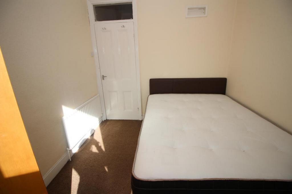 Spacious double bedroom featuring ample natural...