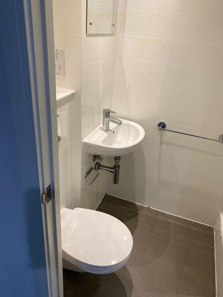 This modern single toilet features a sleek desi...