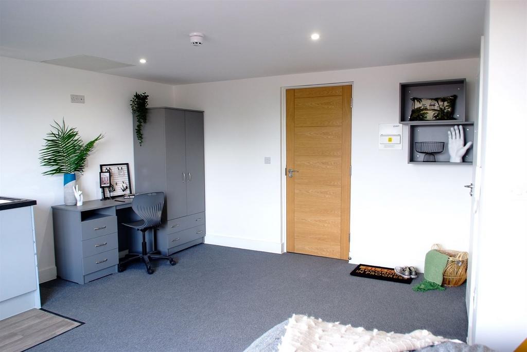 A stylish and cozy double bedroom featuring a w...